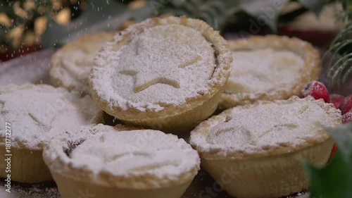 Sprinkling icing sugar on Christmas Mince pies photo