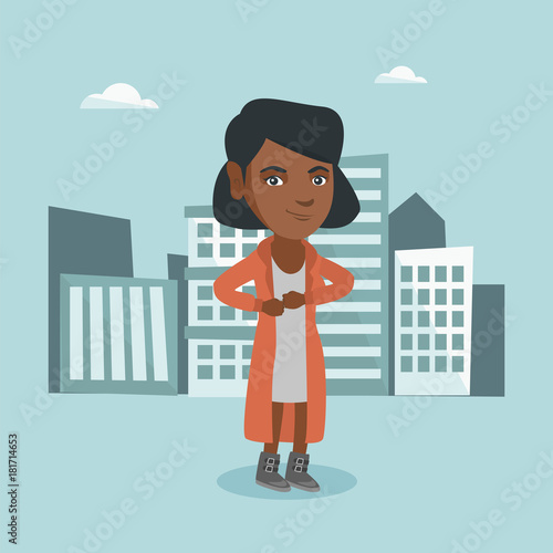 Young african-american business woman standing on the background of city business buildings and taking off her coat like a superhero