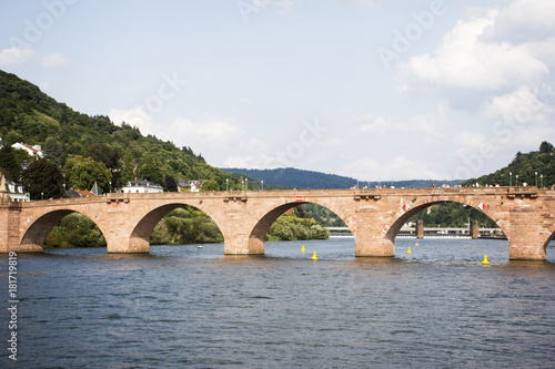 German and foreigner travelers walking and visit on Karl Theodor Bridge or Old Bridge of Heidelberg cross over Neckar River © tuayai