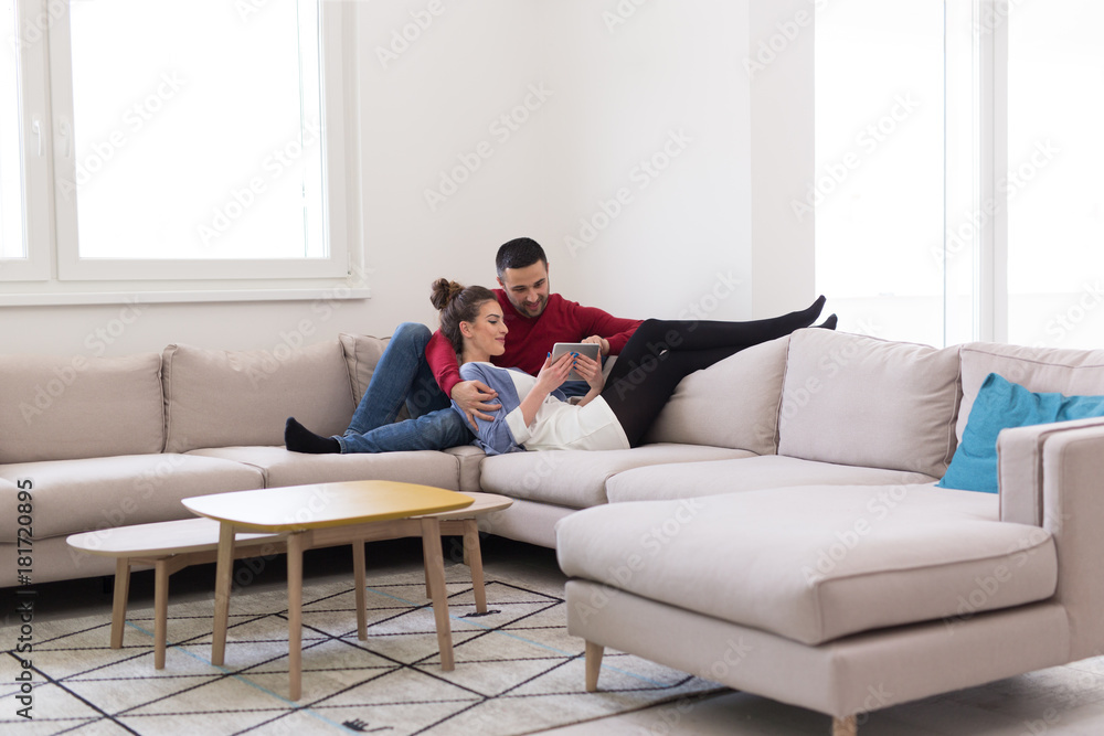 couple relaxing at home with tablet computers couple relaxing at home with tablet computers