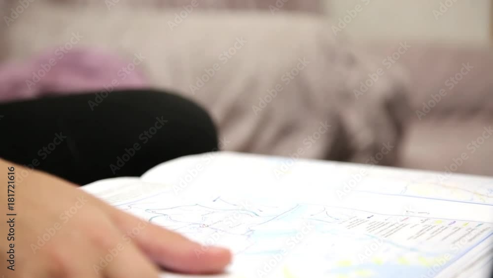 Child's hand with a color pencil. A child paints a geographical map of the world for a school assignment with colored pencils Child's hand with a color pencil. A child paints a geographical map of the world for a school assignment with colored pencils