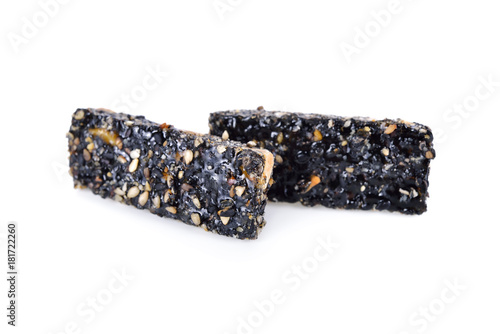 sweetened black sesame stick on white background photo