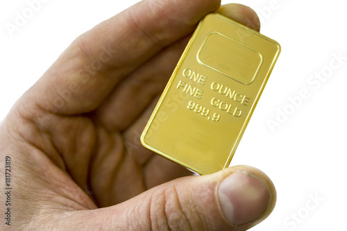Photography A small ingot of gold in his hand. One ounce of gold. Show gold.