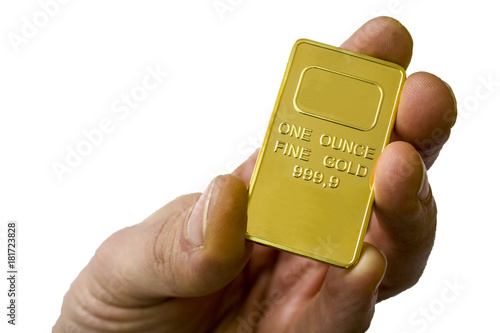 A small ingot of gold in the hand. One ounce of gold. Show gold.
