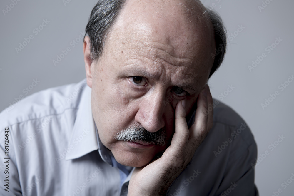 head portrait of senior mature old man on his 60s looking sad and worried suffering pain and depression in sadness face expression