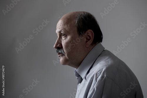 Fototapeta Naklejka Na Ścianę i Meble -  head portrait of senior mature old man on his 60s looking sad and worried suffering pain and depression in sadness face expression