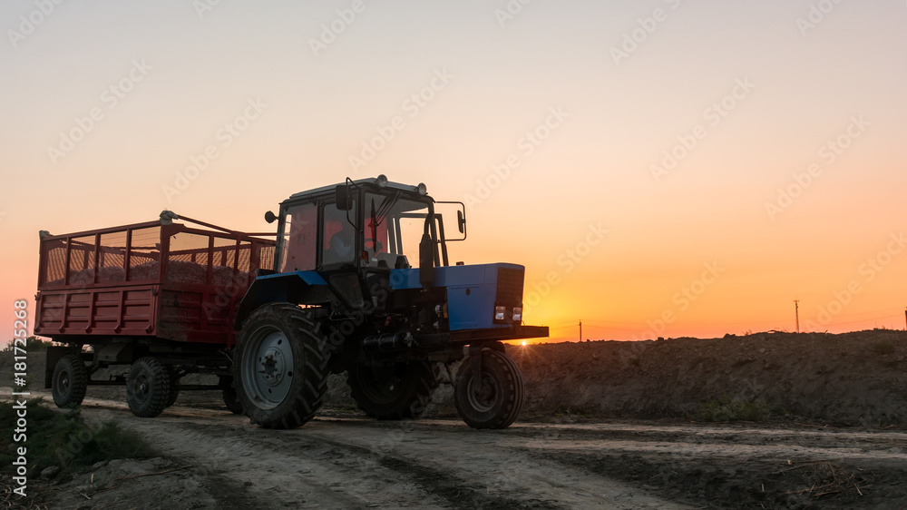Fototapeta premium Farm tractor with a trailer