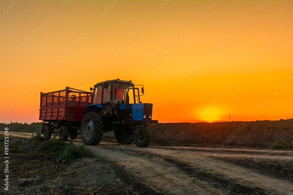 Fototapeta premium Farm tractor with a trailer