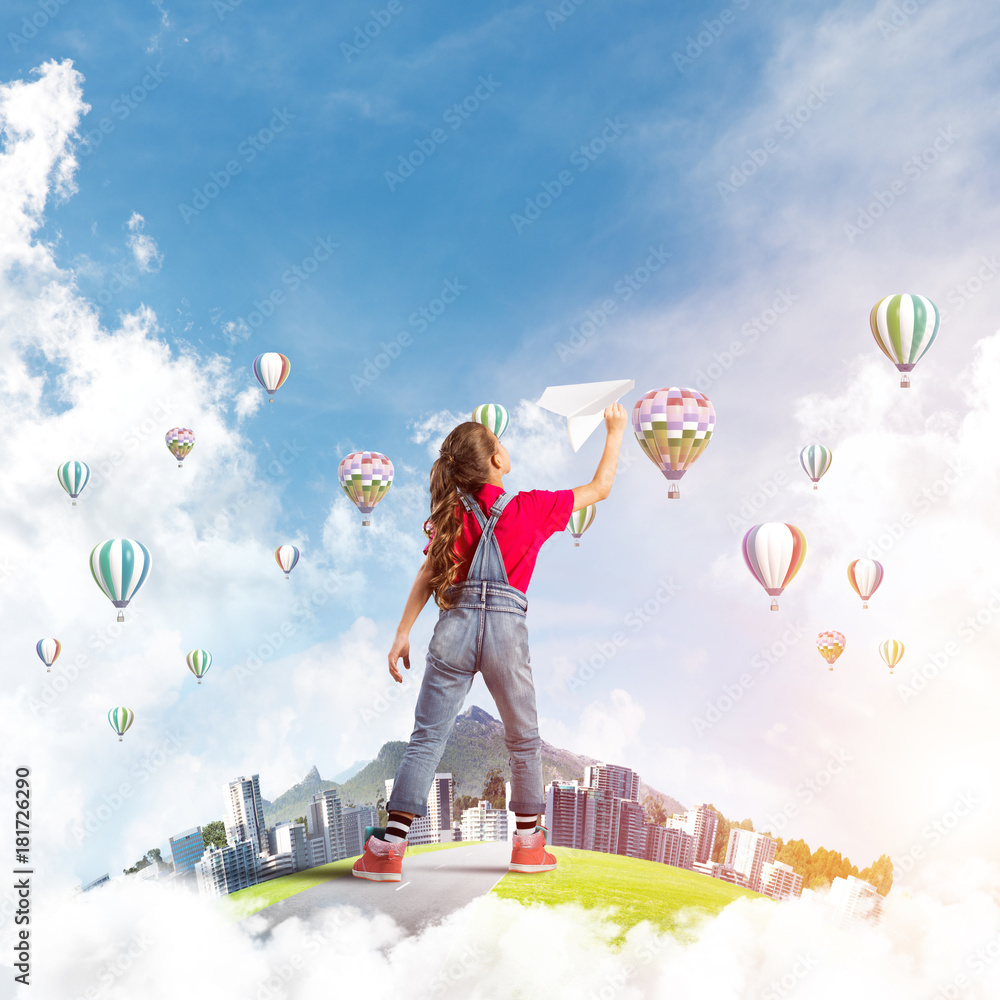 Fototapeta premium Concept of careless happy childhood with girl dreaming about future
