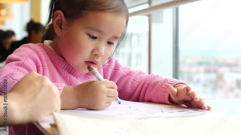 little girl doing homework study indoor by the window little girl doing homework study indoor by the window