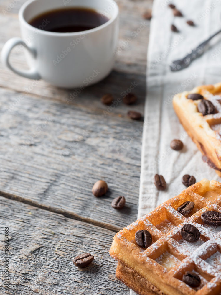 Soft Viennese Belgian waffles with powdered sugar and coffee beans on rustic wooden background Copy space Soft Viennese Belgian waffles with powdered sugar and coffee beans on rustic wooden background Copy space