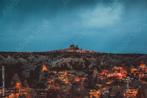 Top view. A small authentic city called Goreme in Cappadocia in Turkey in the evening. Dramatic night sky, storm.