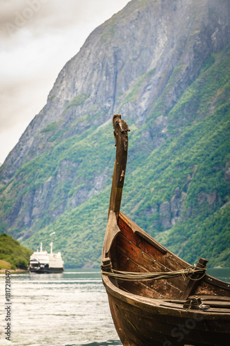 Old viking boat and ferryboat in norwegian fjord