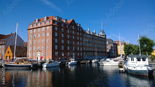 The canals of Copenhagen on a Sunny day. The facades of the houses, the boats, the promenade