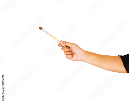 Hand holding eye shadow brush isolated on white background with clipping path. Eye shadow is a cosmetic that is applied on the eyelids and under the eyebrows.