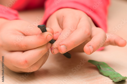 children s hands play with plasticine