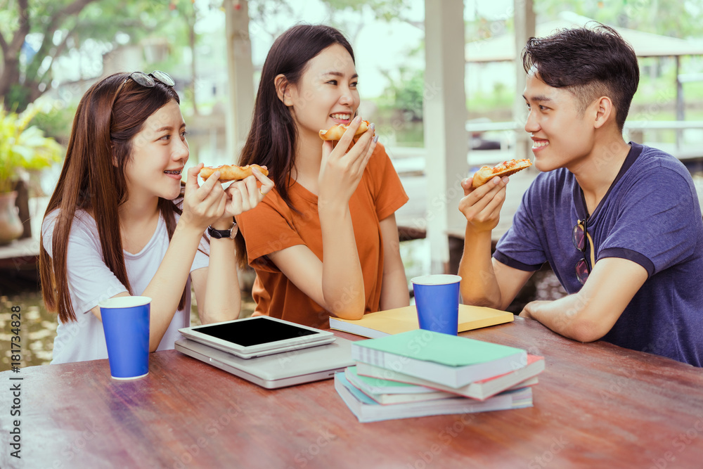 Students asian group together eating pizza in breaking time early next study class having fun and enjoy party italian food slice with cheese delicious at university outdoor