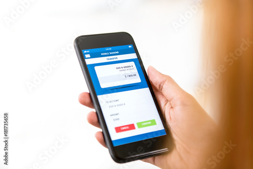 Woman hand using smartphone transferring money online