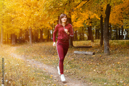 Healthy lifestyle. athletic girl running in the Park and doing exercises Jogging. © malkovkosta