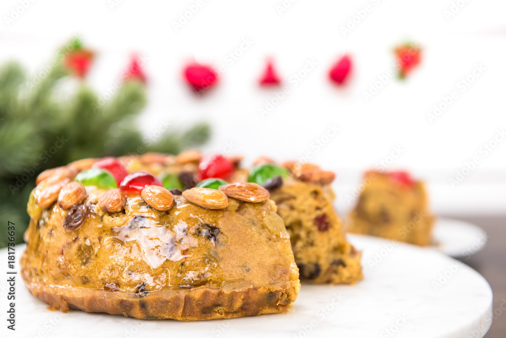 Beautiful delicious homemade Christmas fruit cake on white platter Beautiful delicious homemade Christmas fruit cake on white platter