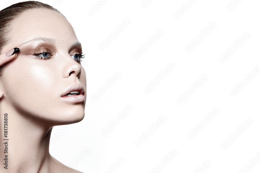 Fototapeta premium Beautiful woman portrait with white skin, fashion make up and with hand touching her eye.
