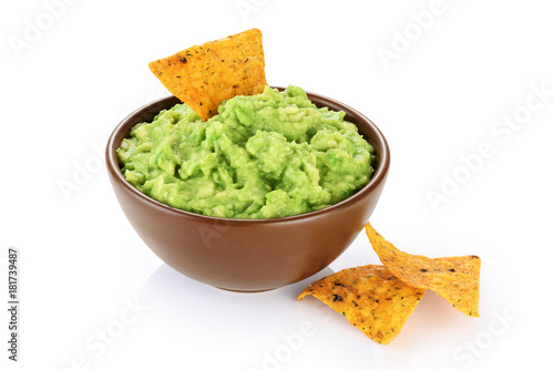 Bowl with guacamole and nachos isolated on white background.