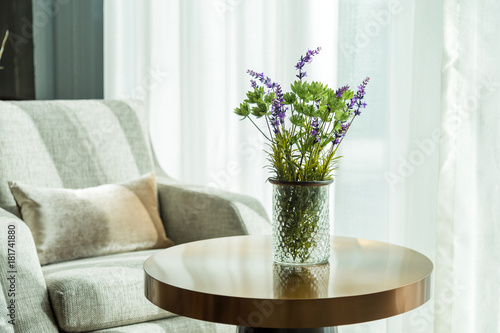 Green flowers and Purple flowers in vase on the table in living room