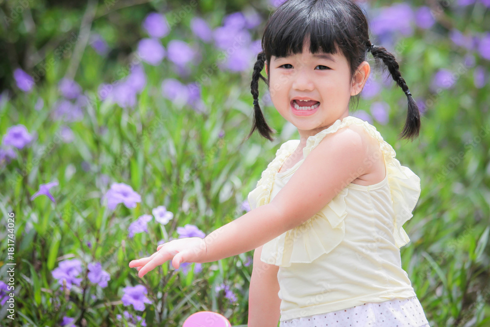 Little girl watering plants in a garden , Kids Gardening Little girl watering plants in a garden , Kids Gardening