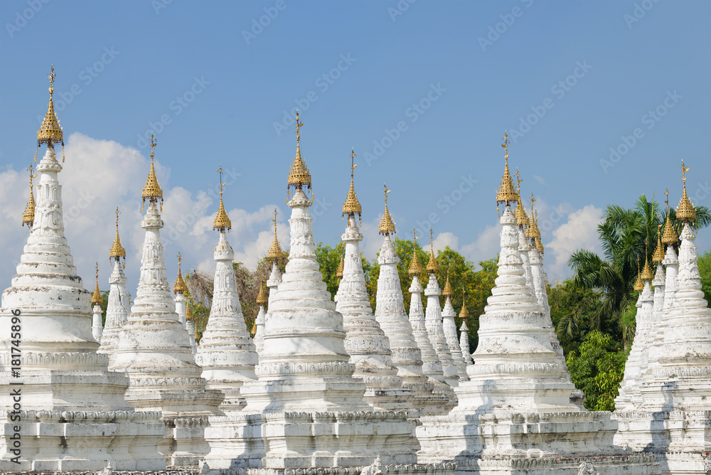 A view of the stupas on the Sandamuni pagoda on a Sunny day. Mandalay, Myanmar