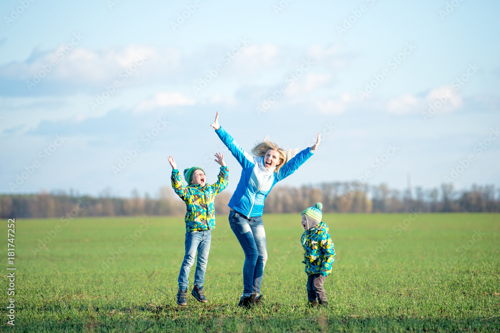 Family walk.Mother and two sons walking in the nature. Family walk.Mother and two sons walking in the nature.
