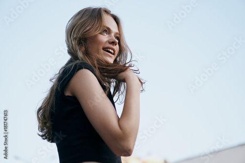 Young beautiful woman against the sky, emotions, smile © SHOTPRIME STUDIO