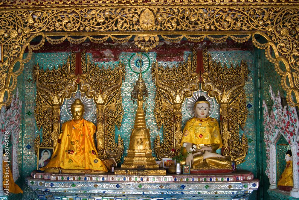 Sculptures of a seated Buddha in one of the pagodas of the Shwedagon temple complex. Yangon, Myanmar