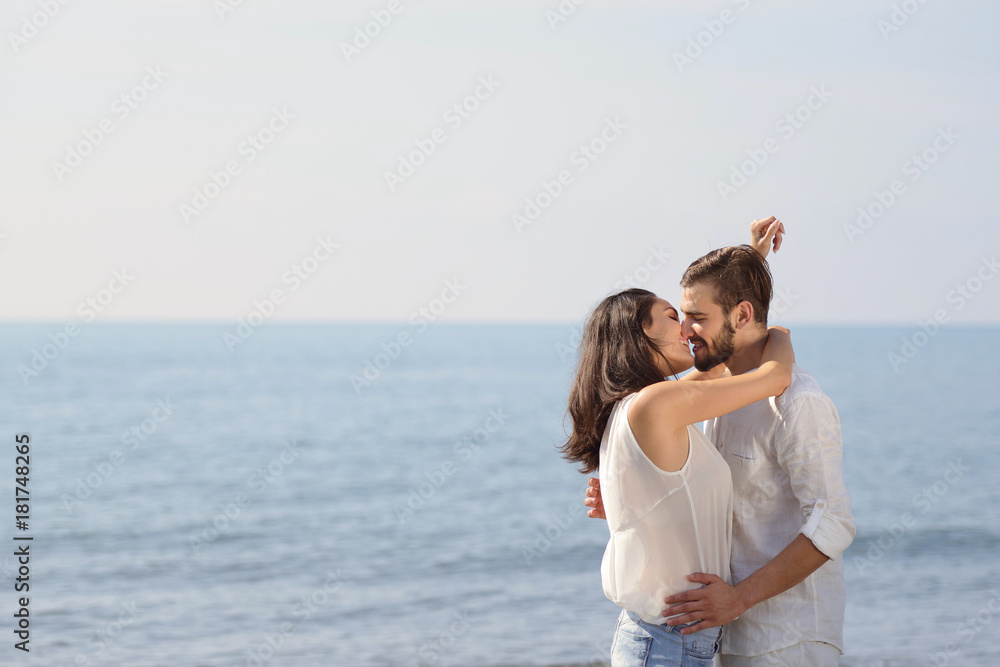 Romantic young couple on the beach kissing. Romantic young couple on the beach kissing.