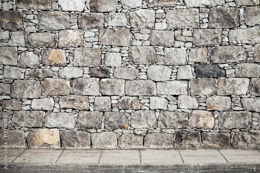 Naklejka premium Texture, gray stone wall and floor tiling