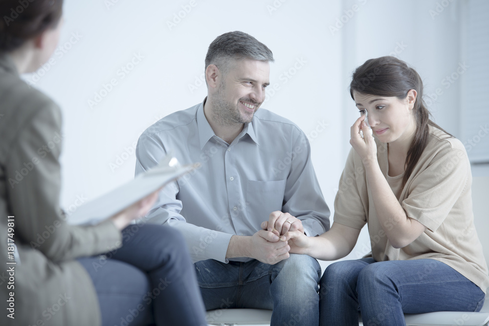 Man comforting crying wife Man comforting crying wife