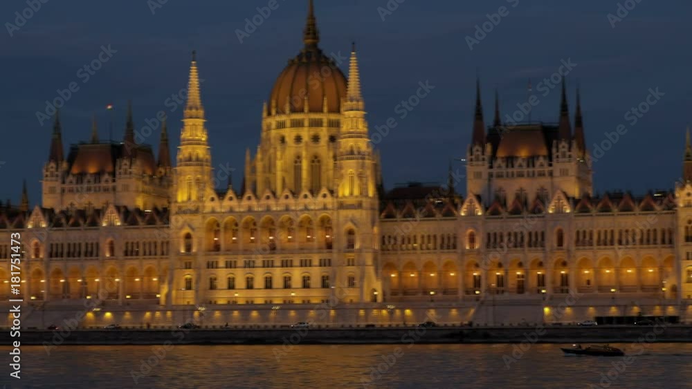 Pan across the facade of the Hungarian Parliament in Budapest during twilight. The building is all lit up Pan across the facade of the Hungarian Parliament in Budapest during twilight. The building is all lit up