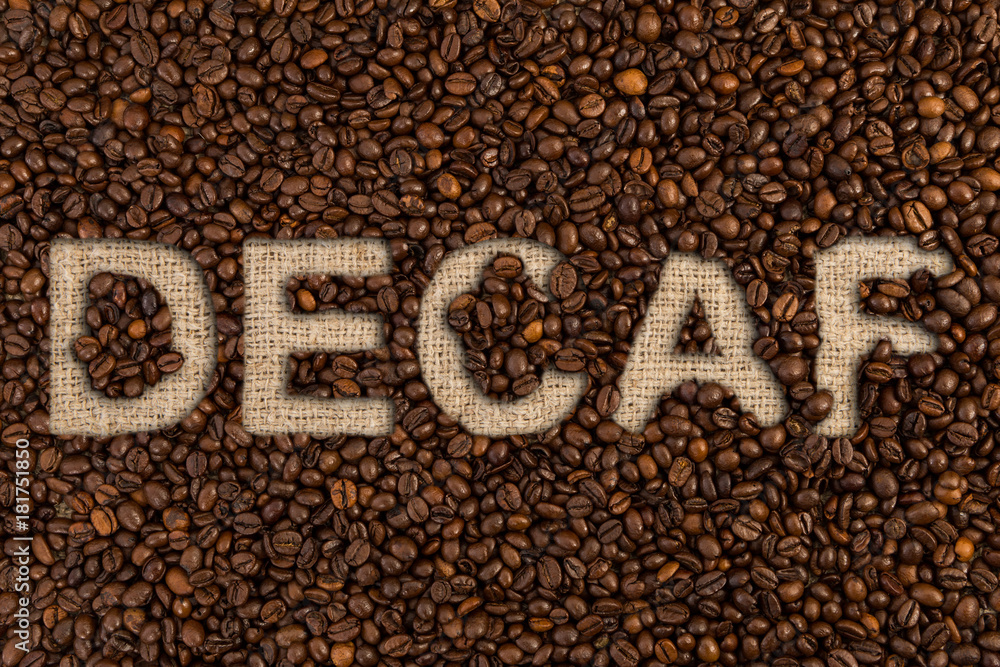 Decaf concept written on coffee beans Decaf concept written on coffee beans