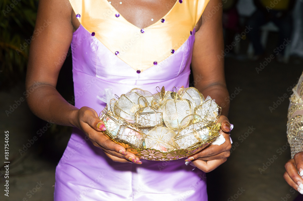young bride holding a bowl of wrapped candies young bride holding a bowl of wrapped candies