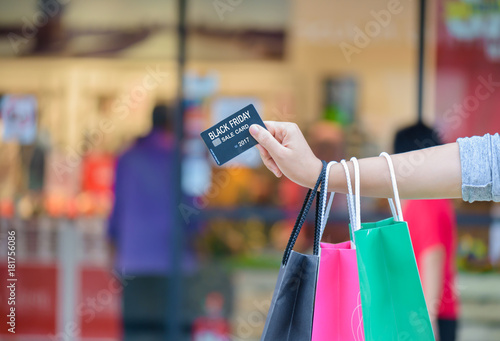 Closeup woman holding shopping bags in the shopping mall, Black Friday sale concept.