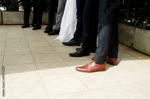 Feet of the bride and groom and his groomsmen