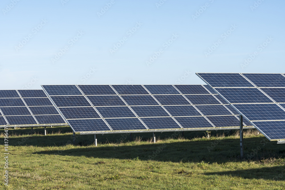Commercial solar panels on bright day in the English countryside Commercial solar panels on bright day in the English countryside