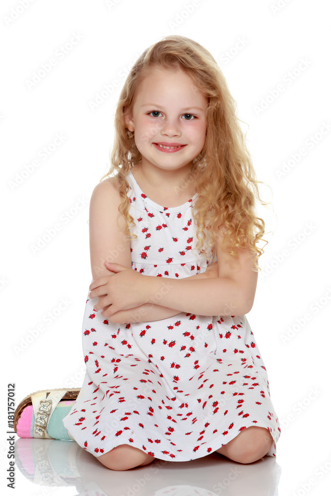 Little girl is sitting on the floor. Little girl is sitting on the floor.