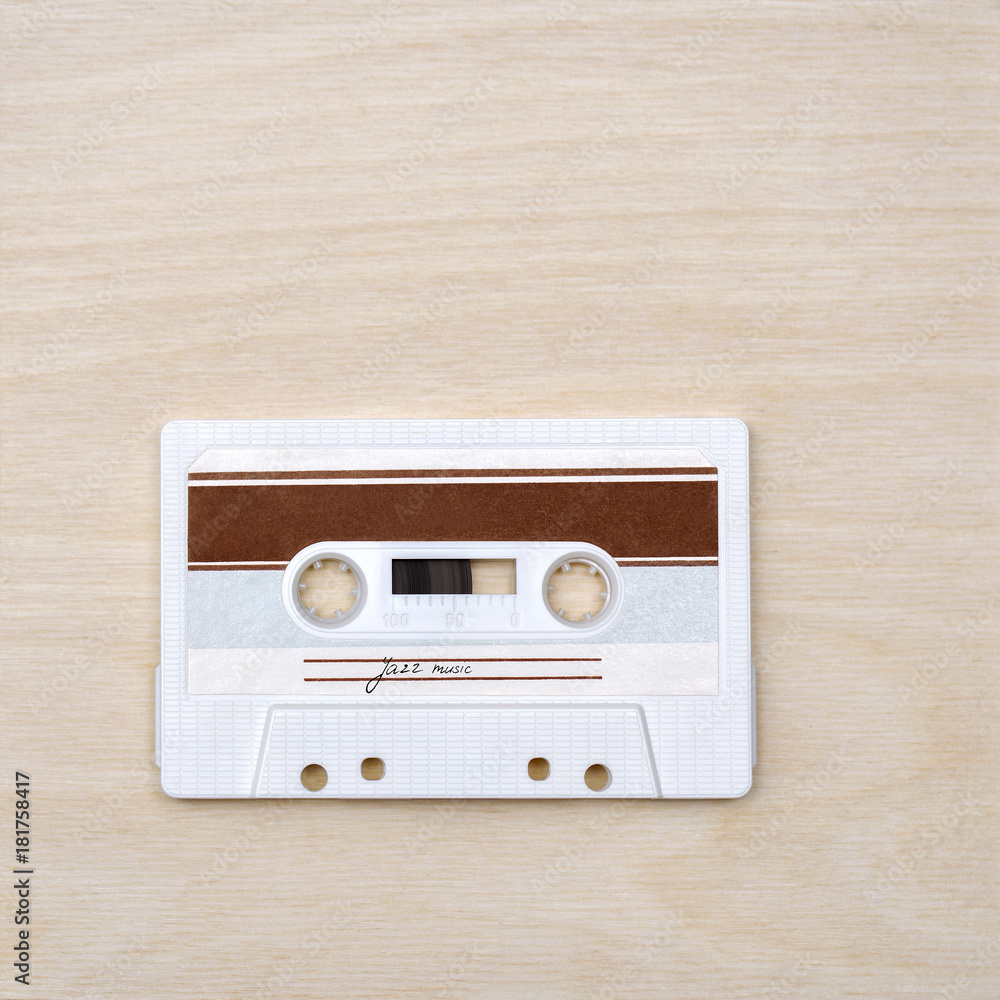 Fototapeta premium Vintage audio cassette tape with jazz music on wooden background