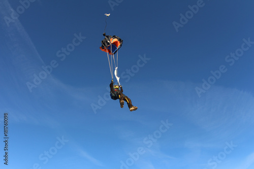 Skydiver is opening a parachute.