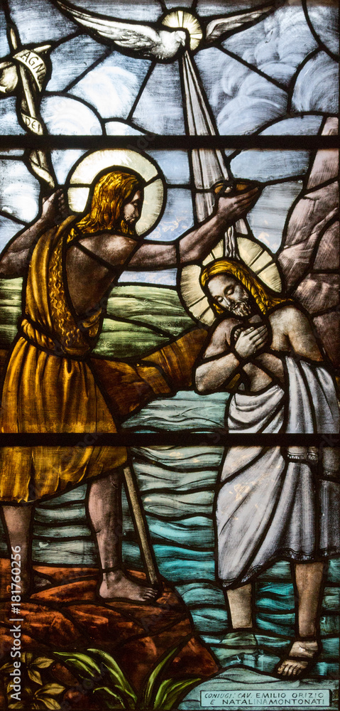 Casorate Primo, Italy. October 26 2017. Stained glass depicting the baptism of Jesus Christ by John the Baptist. San Vittore Martire Church (Church of Saint Victor Maurus or the Moor the martyr) Casorate Primo, Italy. October 26 2017. Stained glass depicting the baptism of Jesus Christ by John the Baptist. San Vittore Martire Church (Church of Saint Victor Maurus or the Moor the martyr)
