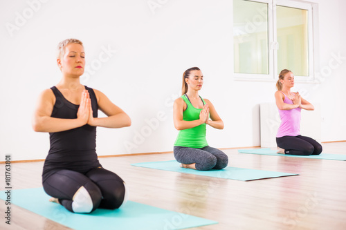 Three girls practicing yoga, Padmasana / Half lotus Position 