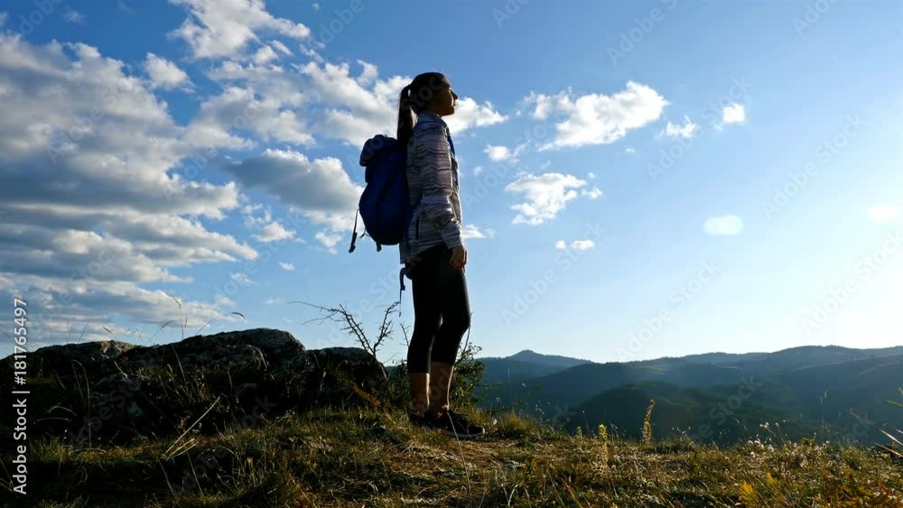 Low angle of woman on top of mountain at Sunset Hiker Girl celebrating life scenic nature landscape enjoying vacation travel adventure, 4k Low angle of woman on top of mountain at Sunset Hiker Girl celebrating life scenic nature landscape enjoying vacation travel adventure, 4k