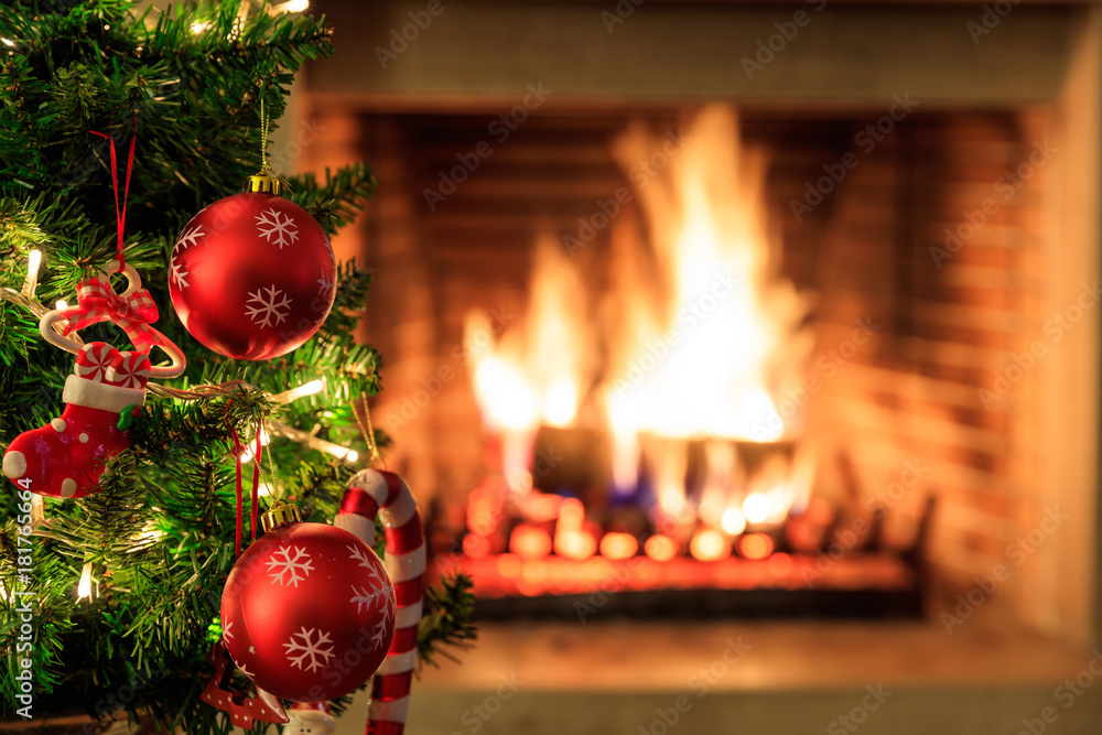 Christmas tree on burning fireplace background Photos | Adobe Stock