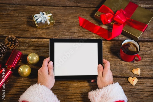 Santa Claus holding digital tablet