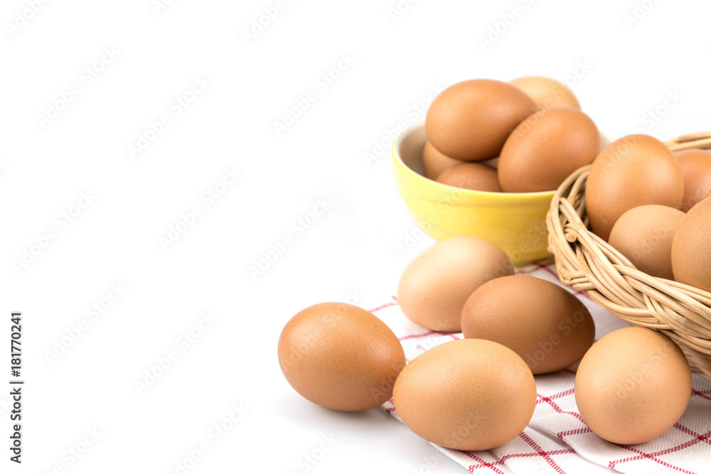 Eggs on cloth with mini basket in the background , isolated on white background